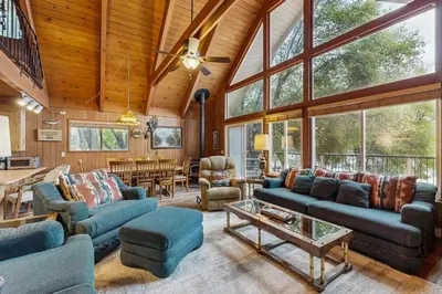 a living room with blue couches and a table at Allen Edgewater Retreat in Groveland