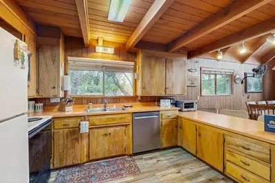 a large kitchen with wooden cabinets and a sink at Allen Edgewater Retreat in Groveland