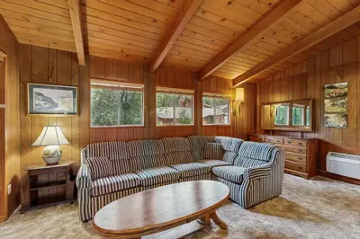 a living room with two couches and a table at Allen Edgewater Retreat in Groveland