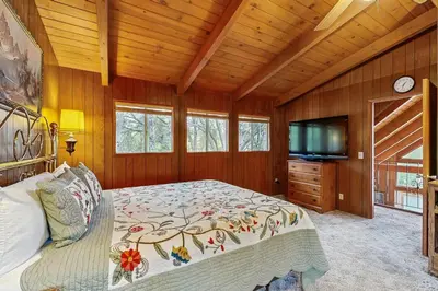 a bedroom with a bed and a flat screen tv at Allen Edgewater Retreat in Groveland