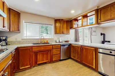 a kitchen with wooden cabinets and a sink at Makoto in Stateline