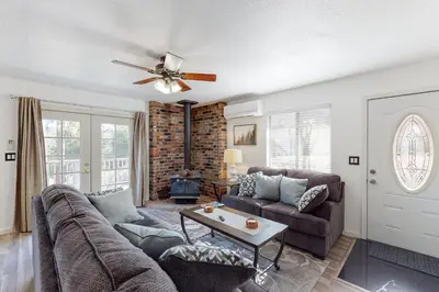 a living room with a couch and a ceiling fan at Holiday Chalet in Groveland