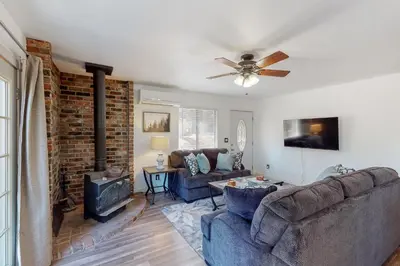a living room with two couches and a brick wall at Holiday Chalet in Groveland