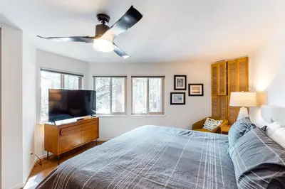 a bedroom with a bed and a flat screen tv at Among the Trees in Incline Village