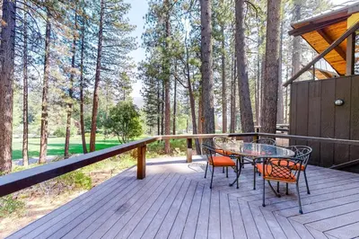 a wooden deck with a table and chairs on it at Among the Trees in Incline Village