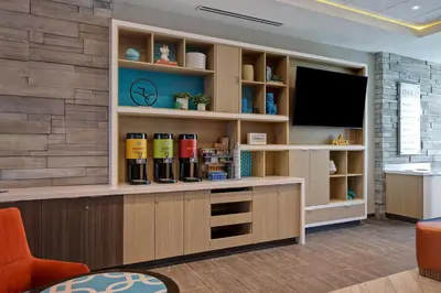 a waiting room with a flat screen tv on a wall at Home2 Suites By Hilton Turlock, Ca in Turlock