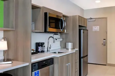 a small kitchen with a sink and a refrigerator at Home2 Suites By Hilton Turlock, Ca in Turlock