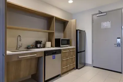 a kitchen with a sink and a refrigerator at Home2 Suites By Hilton Turlock, Ca in Turlock