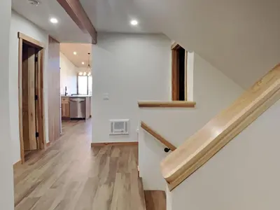 an empty hallway with stairs in a house at Spacious 3 BR Condo with Loft in Mammoth Lakes
