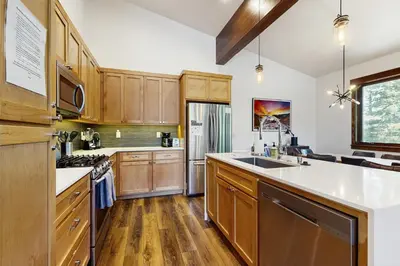 a large kitchen with wooden cabinets and a sink at Truckee Treat in Truckee