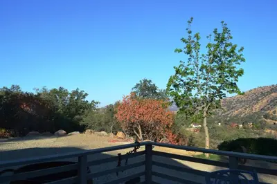 a wooden fence with a view of a mountain at In The Oaks in Three Rivers