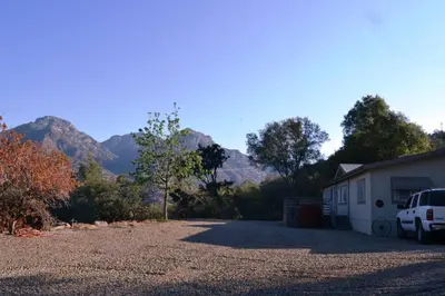 a car parked in front of a house with mountains in the background at In The Oaks in Three Rivers