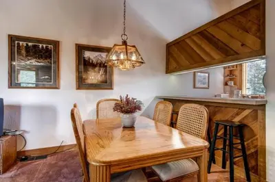 a dining room with a wooden table and chairs at Less Than 1 Mile to Northstar Resort Getaway with Balconies in Truckee