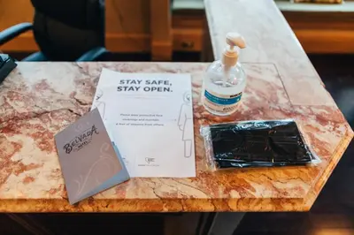 a book and a bottle of water on a table at Belvada Hotel in Tonopah