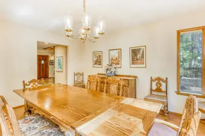 a dining room with a wooden table and chairs at Homewood Bliss in Homewood