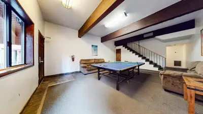 a living room with a ping pong table in it at Helios North #6 condo in Mammoth Lakes