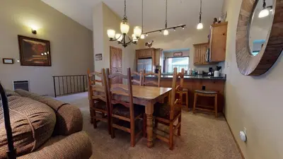 a dining room and kitchen with a table and chairs at Helios North #6 condo in Mammoth Lakes