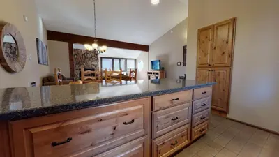 a kitchen with a large counter and a dining room at Helios North #6 condo in Mammoth Lakes