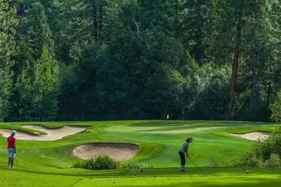two people playing golf on a golf course at Linda's Lakehouse in Incline Village