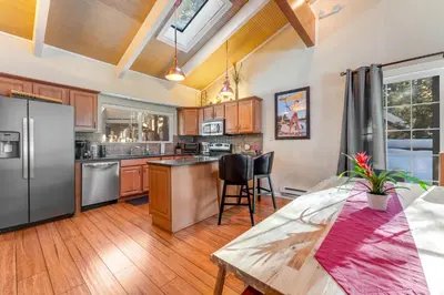 a kitchen with a stainless steel refrigerator and a table at Linda's Lakehouse in Incline Village
