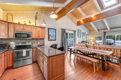 a kitchen with wooden cabinets and a table in it at Linda's Lakehouse in Incline Village