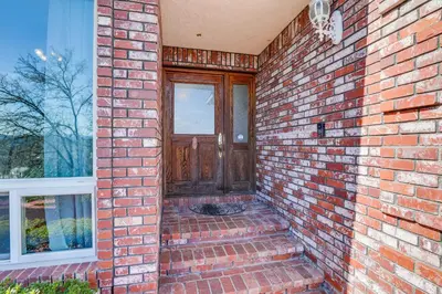 a brick house with a wooden door and stairs at Pet-Friendly Jackson Wine Country Home with Pool! in Jackson