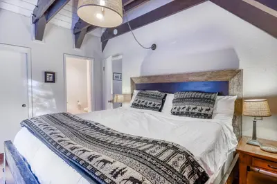 a bedroom with a large bed with a wooden headboard at Eska's Escape in Soda Springs