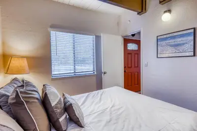 a bedroom with a white bed and a window at Eska's Escape in Soda Springs