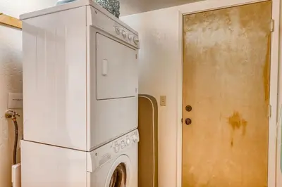 a kitchen with a refrigerator and a washing machine at Eska's Escape in Soda Springs