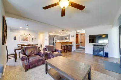 a living room with a ceiling fan and a table at Snowcreek Resort Condo with Deck at Mammoth Mountain in Mammoth Lakes