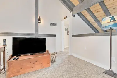 a living room with a large flat screen tv at La Vista Blanc 78 in Mammoth Lakes