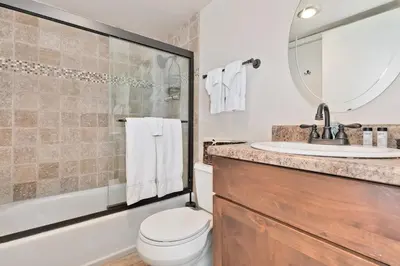 a bathroom with a toilet and a sink and a mirror at La Vista Blanc 78 in Mammoth Lakes