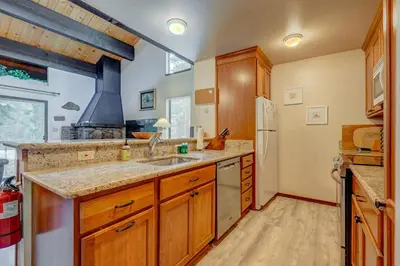 a kitchen with a sink and a refrigerator at Kings Beach Bliss in Kings Beach