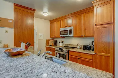 a kitchen with wooden cabinets and a granite counter top at Kings Beach Bliss in Kings Beach