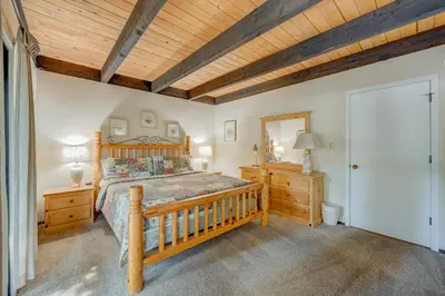 a bedroom with a wooden bed and a wooden ceiling at Kings Beach Bliss in Kings Beach