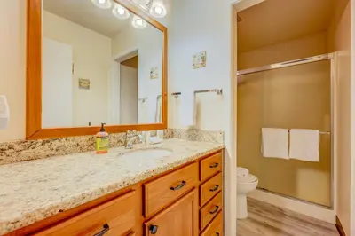 a bathroom with a sink and a mirror and a toilet at Kings Beach Bliss in Kings Beach