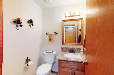 a bathroom with a toilet and a sink and a mirror at Summer Creek in Groveland