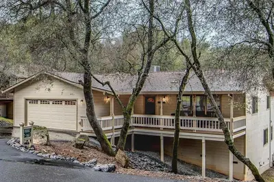 a large house with a porch and a garage at Summer Creek in Groveland