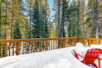 a red chair sitting on a deck in the snow at Sugar House in Soda Springs
