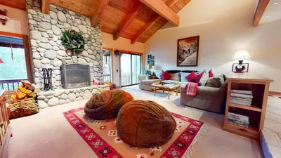 a living room with a stone fireplace and a couch at Val D'Isere #9 condo in Mammoth Lakes