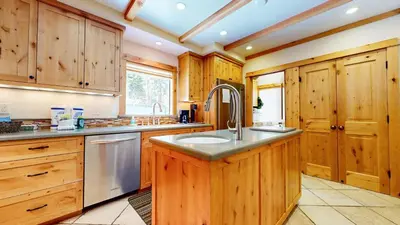 a kitchen with wooden cabinets and a sink at Val D'Isere #9 condo in Mammoth Lakes