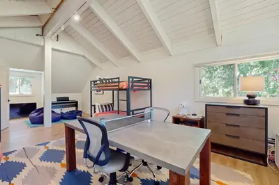 a room with a table and chairs and a bunk bed at Bearing Drive Escape in Tahoe City