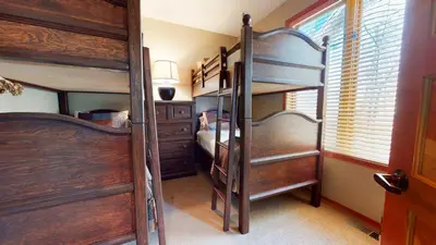 a bedroom with two bunk beds and a window at Snowcreek V #774 condo in Mammoth Lakes