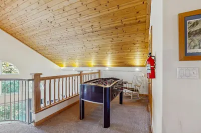 a room with a table and a balcony at Boat House in Soda Springs