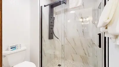 a bathroom with a glass shower with a toilet at Eagle Run #103 condo in Mammoth Lakes