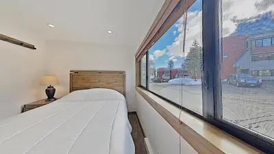 a bedroom with a bed and a large window at 1849 Condos 562 home in Mammoth Lakes