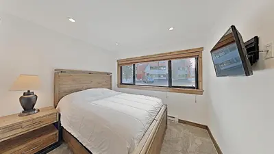 a bedroom with a bed and a tv and a window at 1849 Condos 562 home in Mammoth Lakes