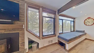 a room with a fireplace and a clock on the wall at 1849 Condos 562 home in Mammoth Lakes