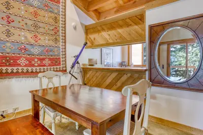 a dining room with a table and a mirror at Northstar Perch in Truckee