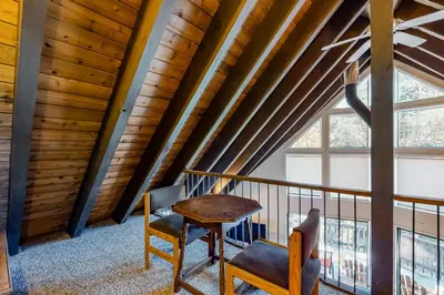 a table and two chairs in a room with a ceiling at Hillside Haven in Soda Springs